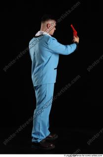 042018 01  MIKAEL STANDING POSE WITH RED PISTOL